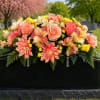 Heavenly Sunset Saddle is a vibrant cemetery tribute designed in warm peaches
