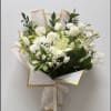Soft white lilies and roses take center stage in this sympathy flower