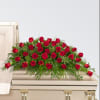 A dense spray of deep red roses laid across the top of