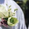 Small boutonniere with white roses and pale green flowers