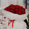 A beautiful, custom wrapped fresh flower bouquet of 100 long stem Roses.