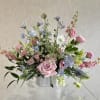A soft, garden-style arrangement is a pastel flower arrangement perfect for birthdays