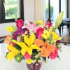 Bright yellow lilies take center stage in this Summer Fun bouquet, a
