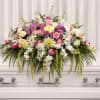 Soft white roses and blushing pink carnations form a serene, full altar