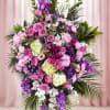 A lush, formal standing spray that reads as both a tender sympathy