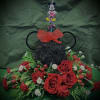 Mickey Mouse-themed floral arrangement with red roses and daisies