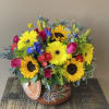 Vibrant and colorful flowers arranged in a keepsakes cooking pot. Perfect for