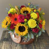 Vibrant colorful arrangement includes a variety of flowers. The vase (pot) is