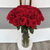 Large bouquet of red roses in a clear glass vase