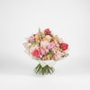 Featuring a lush medley of premium seasonal blooms in dreamy blush, champagne