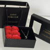 Black gift boxes with red roses and a crescent necklace