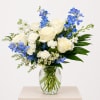 A refined hand-designed flower arrangement featuring premium ivory roses accented with soft