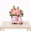 A charming flower arrangement featuring soft pink roses and delicate seasonal blooms