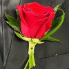 Red rose boutonniere pinned to a black suit jacket