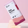 Pink sea salt dark chocolate bar on a pink background