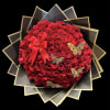 Round bouquet of red roses with a red ribbon and butterfly accents