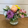 Apricot roses and a large lavender chrysanthemum with white daisies, yellow button