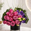 A luxurious modern arrangement featuring premium hot pink roses accented with rich