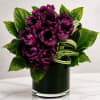 A dramatic and luxurious floral arrangement featuring rare deep plum fringed tulips