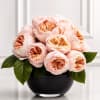 An elegant luxury arrangement featuring premium garden roses in soft champagne and