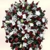 A formal standing spray in a classic red-and-white palette, designed as a