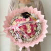 A lush cascade of fifty pink and cream roses arranged into a