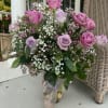 Lavender Whisper is a soft, romantic design built around elegant lavender roses