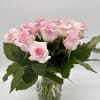 Pink roses arranged in a clear glass vase