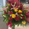 Roses, lilies, and mixed flower fillers arranged in Asian style on glass