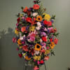 Large colorful standing floral spray on an easel