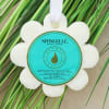 A bright, spa-inspired bath sponge shaped like a white wildflower brings a