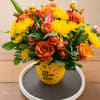 Brighten someone's day with this cheerful and uplifting floral arrangement designed to