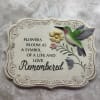 This garden stone shows a Hummingbird and florals with a commemorating phrase:
"Flowers
