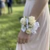 An elegant and classic wrist corsage featuring 3 premium white spray roses