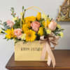 A sunny bouquet gathered in a pale-yellow gift bag, this cheerful flower