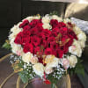 Heart-shaped bouquet of red and white roses with butterfly picks