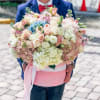 Large pastel bouquet of roses and hydrangeas in a pink box