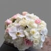 Ivory and blush roses mingled with white phalaenopsis orchids and cloud-like hydrangeas
