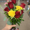 Bouquet of red and yellow roses with a decorative ribbon