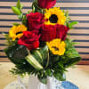 Red roses and sunflowers in a white jar 