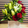 White lilies and red roses in a wood box 