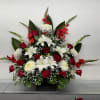 A striking one-sided arrangement featuring radiant red roses, elegant white lilies, crisp