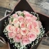Bouquet of pale pink roses with baby's breath in black wrap
