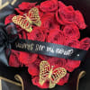Red rose bouquet with black ribbon and gold butterfly decorations