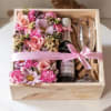 Pink floral gift box with a champagne bottle and two glasses