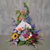Colorful floral arrangement with roses, sunflowers, and a paint palette centerpiece