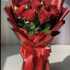 A breathtaking, monochromatic presentation featuring premium, long-stemmed red roses enveloped in a