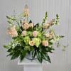 This Vase Arrangement includes Peach Stock, White Snapdragon, Green Mini Hydrangea, Queen