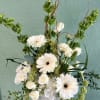 Shown at $140.00 
A tall vased arrangement of high end white and