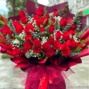 "A breathtaking showstopper featuring 50 premium red roses layered with delicate baby's